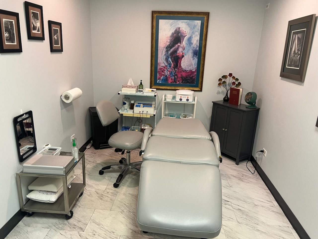 Barbara's private treatment room inside RP Salon and Spa, with a newly upholstered treatment chair and framed art