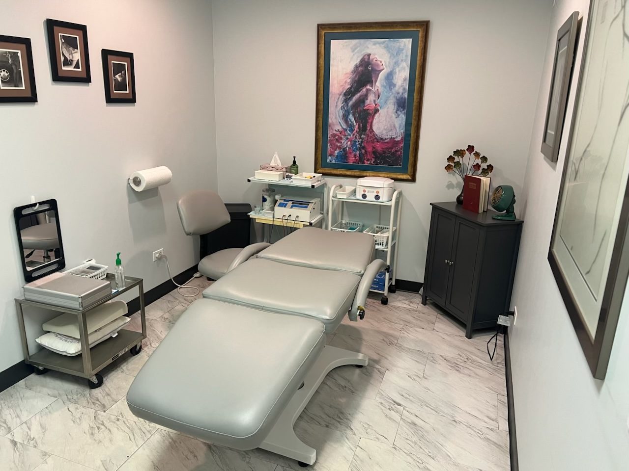 Barbara's electrolysis treatment room with professional equipment and a newly upholstered treatment chair